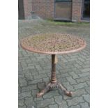 A cast metal circular garden table.