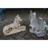 Two composite garden ornaments of a dog and a cat.