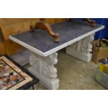 A good large painted stone pedestal table inset with blue mosaic tiles.
