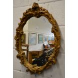 A gilt plaster framed mirror.