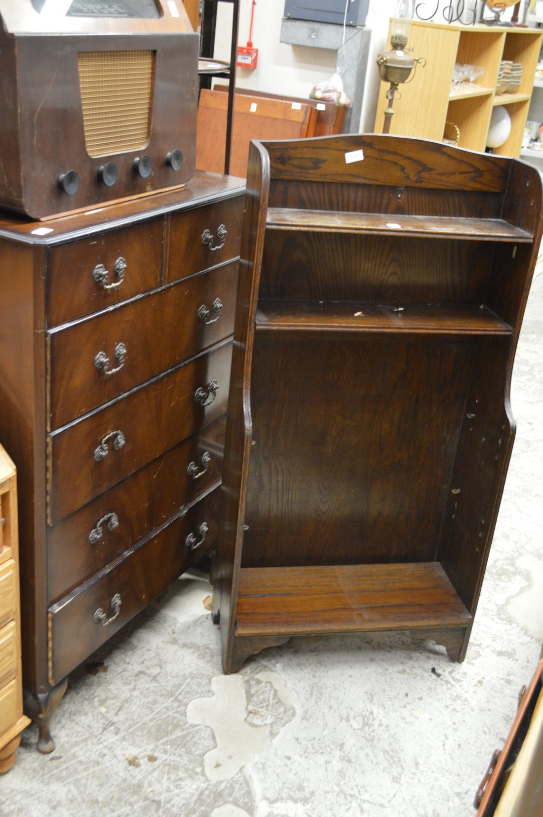 An oak bookshelf and a chest of drawers.