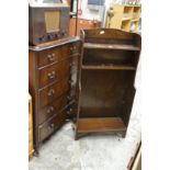 An oak bookshelf and a chest of drawers.