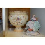 A decorative figurine and a jardiniere.