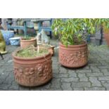 A pair of classical style terracotta circular garden planters.