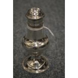 A silver baluster shaped pepperette.