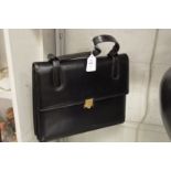 An Asprey black leather handbag.