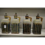 An unusual set of four Doulton Lambeth square shaped turquoise glazed stoneware liqueur bottles (one