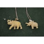 Two elephant pendants.