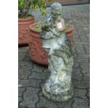 A small composite garden ornament modelled as a young lady holding a basket.