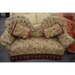 A decoratively upholstered Victorian spoon back settee.