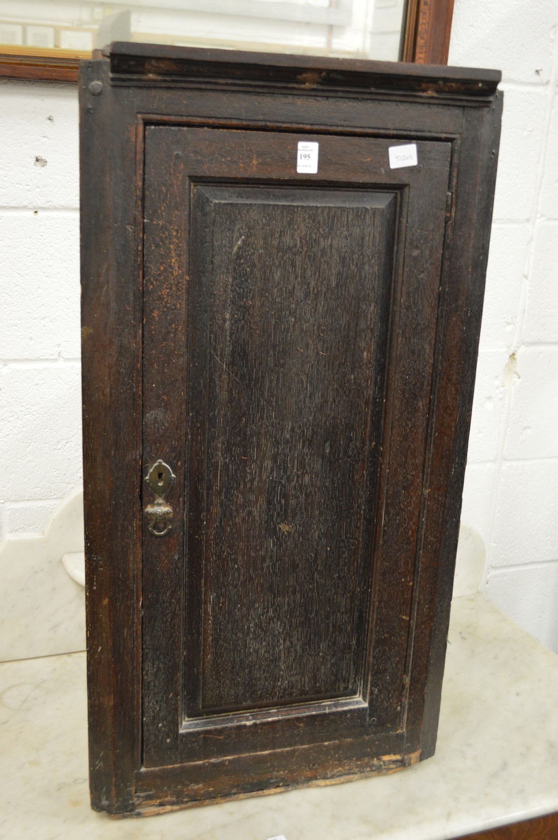 An old oak hanging corner cupboard.