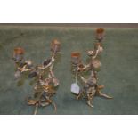 A pair of decorative figural cast metal candelabra.