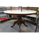 A modern circular marble topped pedestal dining table.