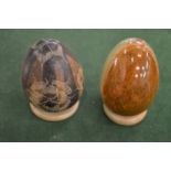 Two decorative hardstone eggs on stands.