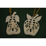 Two carved pendants with chains.