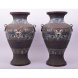 A LARGE PAIR OF CHINESE CHAMPLEVE ENAMEL BRONZE VASES with twin ring handles, the body of each