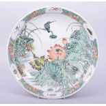 A CHINESE KANGXI STYLE FAMILLE VERTE PORCELAIN DISH, painted with native flora, the base with six