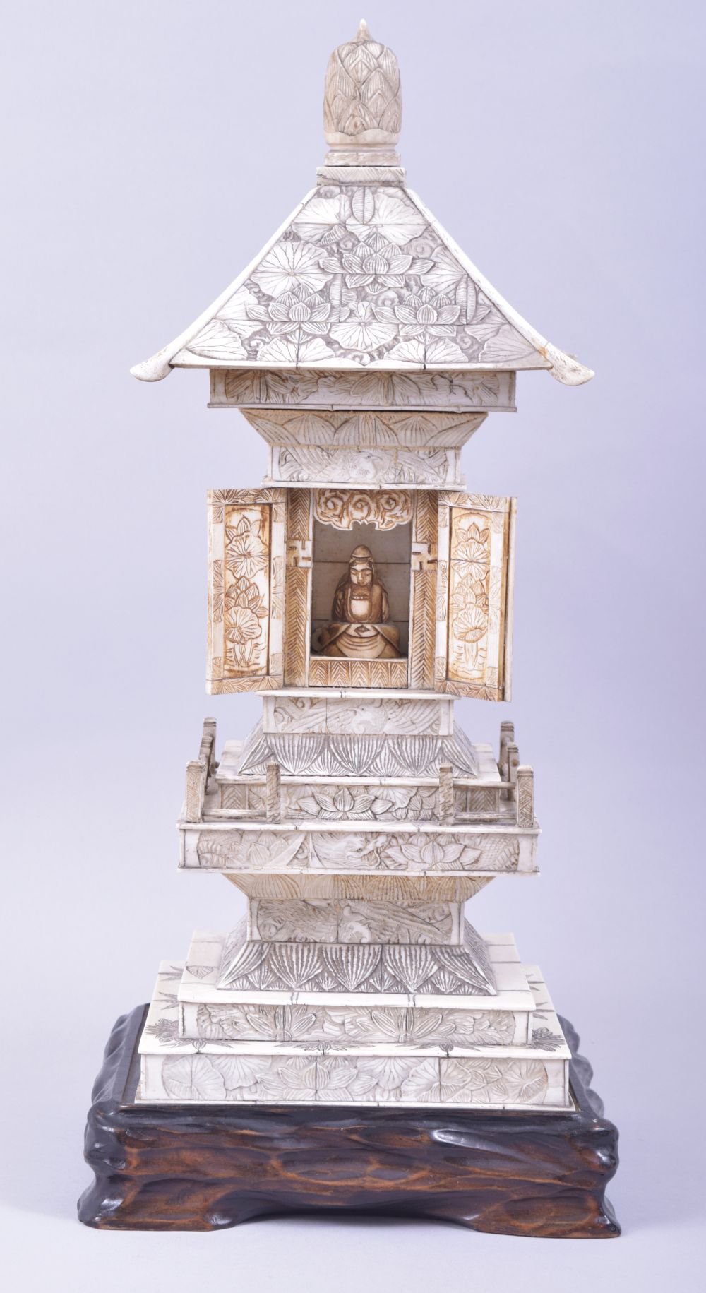 A CHINESE CARVED IVORY TEMPLE / PAGODA SHRINE, the central section with doors opening to reveal a