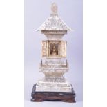 A CHINESE CARVED IVORY TEMPLE / PAGODA SHRINE, the central section with doors opening to reveal a