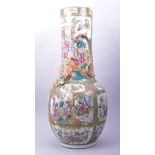 A LARGE CHINESE CANTON FAMILLE ROSE PORCELAIN VASE, painted with panels of figures in a courtyard,