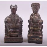 TWO 18TH CENTURY CHINESE CARVED WOODEN IMMORTAL FIGURES, 14cm and 13cm high.