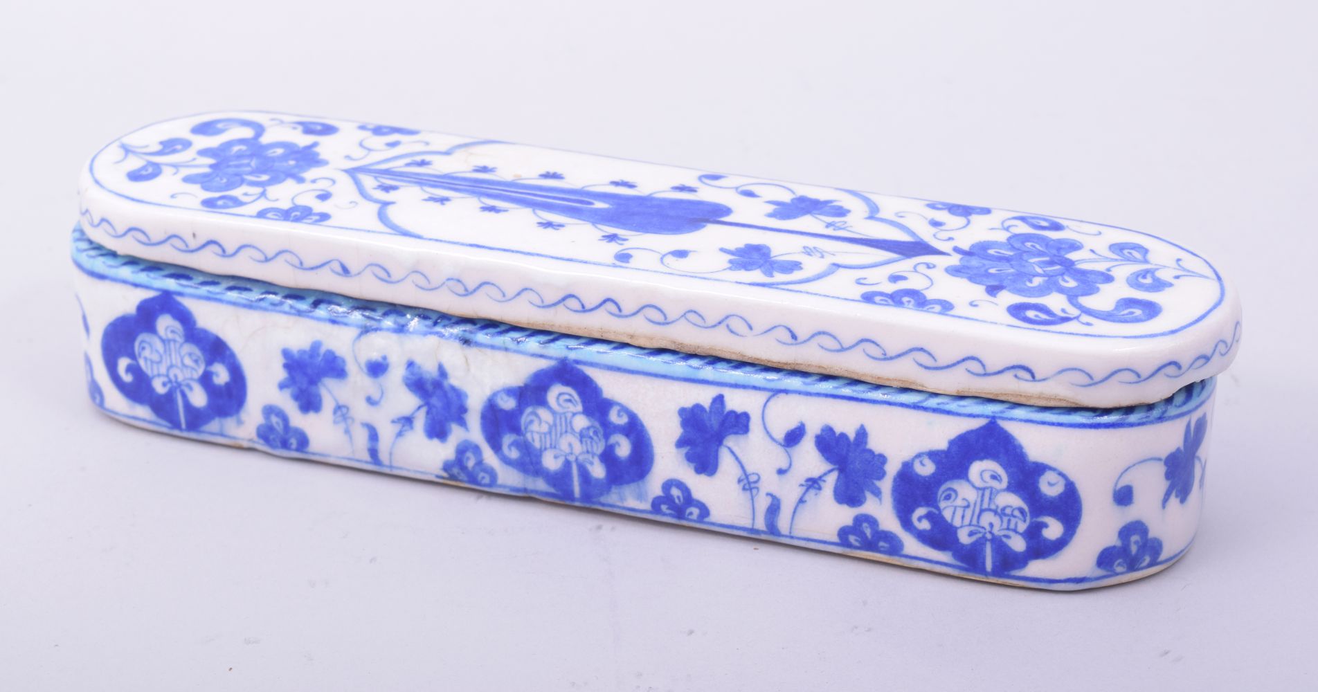 A TURKISH OTTOMAN BLUE AND WHITE GLAZED POTTERY LIDDED PEN BOX, the interior with three