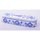 A TURKISH OTTOMAN BLUE AND WHITE GLAZED POTTERY LIDDED PEN BOX, the interior with three