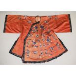 A CHINESE CORAL GROUND EMROIDERED SILK JACKET, embroidered with floral design.