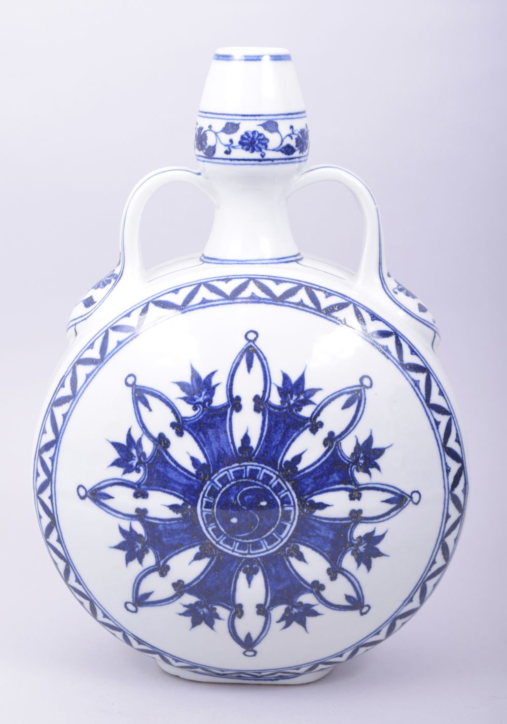 A CHINESE MING STYLE BLUE AND WHITE TWIN HANDLE MOON FLASK, the centre decorated with yin yang