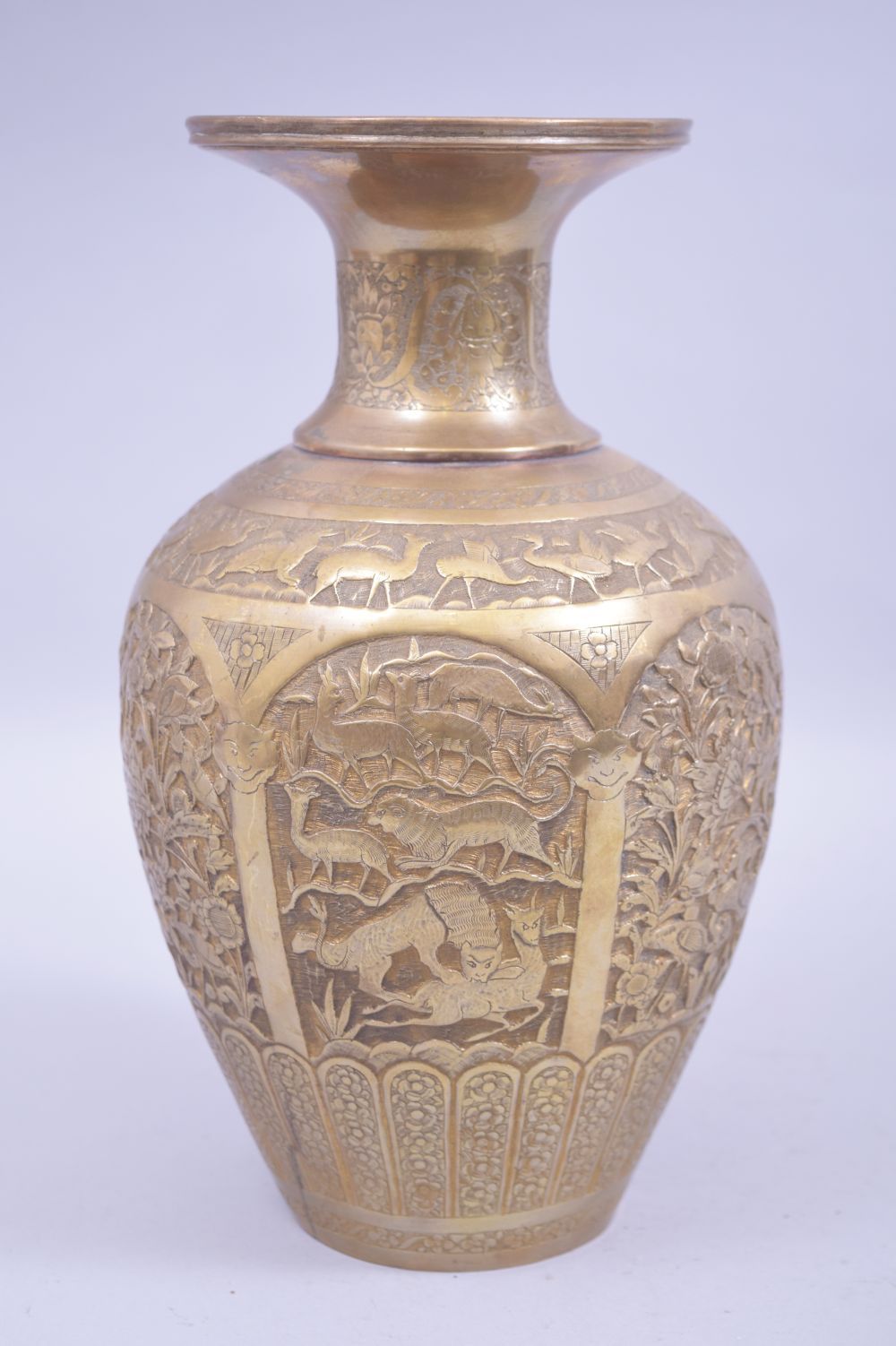 A PERSIAN BRASS RELIEF PANELLED VASE, with panels of animals amongst flora and birds, base soldered,