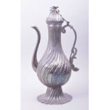 A 19TH CENTURY TURKISH LIDDED SILVER COFFEE POT, the lid with bird finial, 35.5cm high.