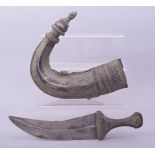 AN EARLY ISLAMIC ARAB OMANI RHINO HORN HILTED SILVER JAMBIYA DAGGER, 30cm long overall.