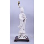 A LARGE BLANC DE CHINE PORCELAIN FIGURAL LAMP, the figure mounted to a hardwood base with lamp