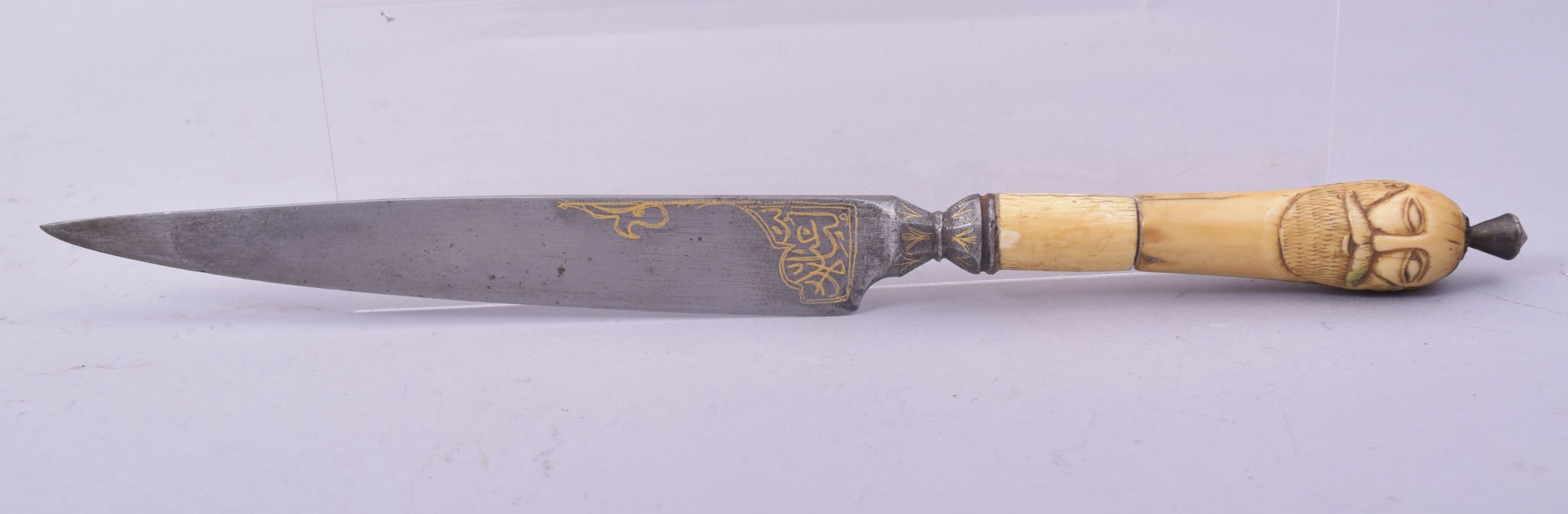 AN UNUSUAL OTTOMAN OR PERSIAN DAGGER with carved walrus handle in the form of a male face to