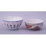 TWO TURKISH KUTAHYA POTTERY BOWLS, each decorated with various floral motifs, 13cm diameter and 11.