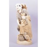 A GOOD LARGE CARVED IVORY FIGURE OF A FISHERMAN, the figure stood upon a carved wave base holding