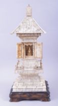 A CHINESE CARVED IVORY TEMPLE / PAGODA SHRINE, the central section with doors opening to reveal a