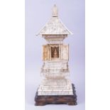 A CHINESE CARVED IVORY TEMPLE / PAGODA SHRINE, the central section with doors opening to reveal a