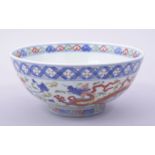 A CHINESE MING STYLE WUCAI PORCELAIN BOWL, painted with dragons and floral decoration, the base with