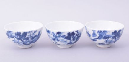 THREE CHINESE BLUE AND WHITE PORCELAIN TEA BOWLS, each painted with a landscape scene, 7.5cm