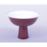 A SMALL CHINESE MING STYLE COPPER RED GLAZED STEM CUP, the interior with blue and white lotus and