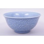 A CHINESE MING STYLE BLUE GLAZED PORCELAIN BOWL, the exterior decorated with dragons amongst