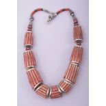 A NEPALI CORAL AND WHITE METAL NECKLACE.