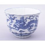 A CHINESE BLUE AND WHITE PETAL SHAPE BOWL, the exterior painted with dragons amongst stylised