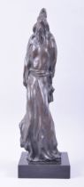 AN ORIENTAL ABSTRACT BRONZE STATUE of a sage like figure, mounted to a square form marble base,