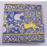 FOUR PERSIAN SAFAVID CUERDA SECA POTTERY TILES, decorated with floral part borders and sections of a