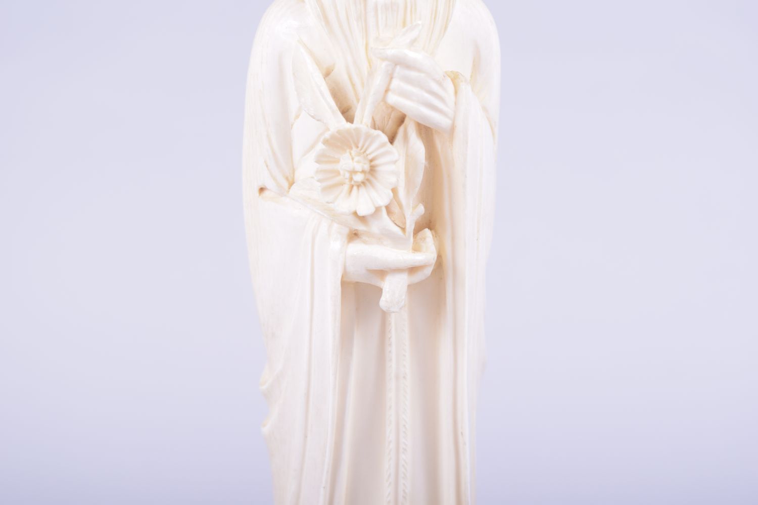 A CHINESE CARVED IVORY FIGURE OF A SAGE holding a flower, mounted to a hardwood base, 23cm high. - Image 6 of 7