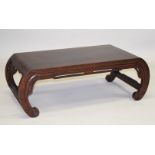 A GOOD CHINESE HARDWOOD LOW TABLE, on four curving end supports, 97cm long, 33cm high, 50cm deep.