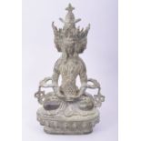 A TIBETAN BRONZE FOUR HEADED SEATED BUDDHIST DEITY, 22.5cm high.