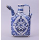 A TURKISH OTTOMAN IZNIK BLUE AND WHITE GLAZED POTTERY EWER, with zoomorphic spout, the base raised